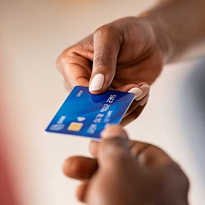 Man handing over credit card to pay for hearing aids